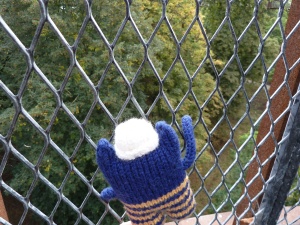 Explorer Beastie scaling the fence