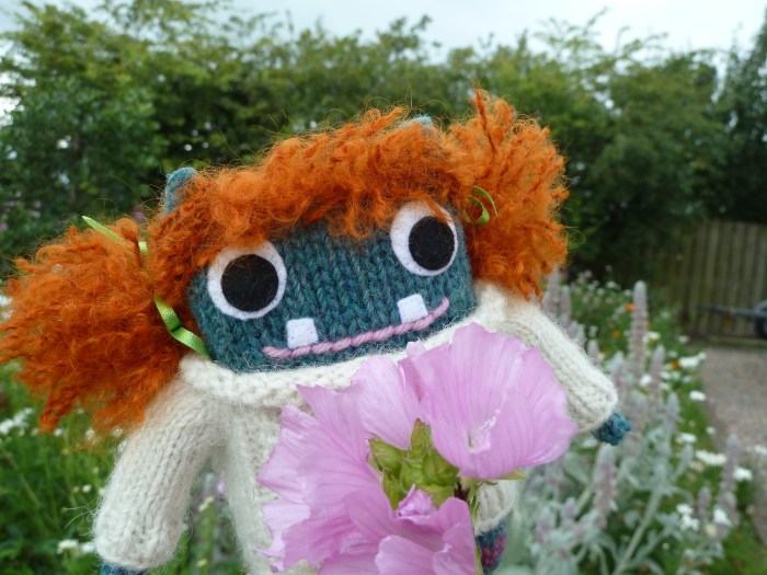 Redhead Beastie among the flowers - CrawCrafts Beasties
